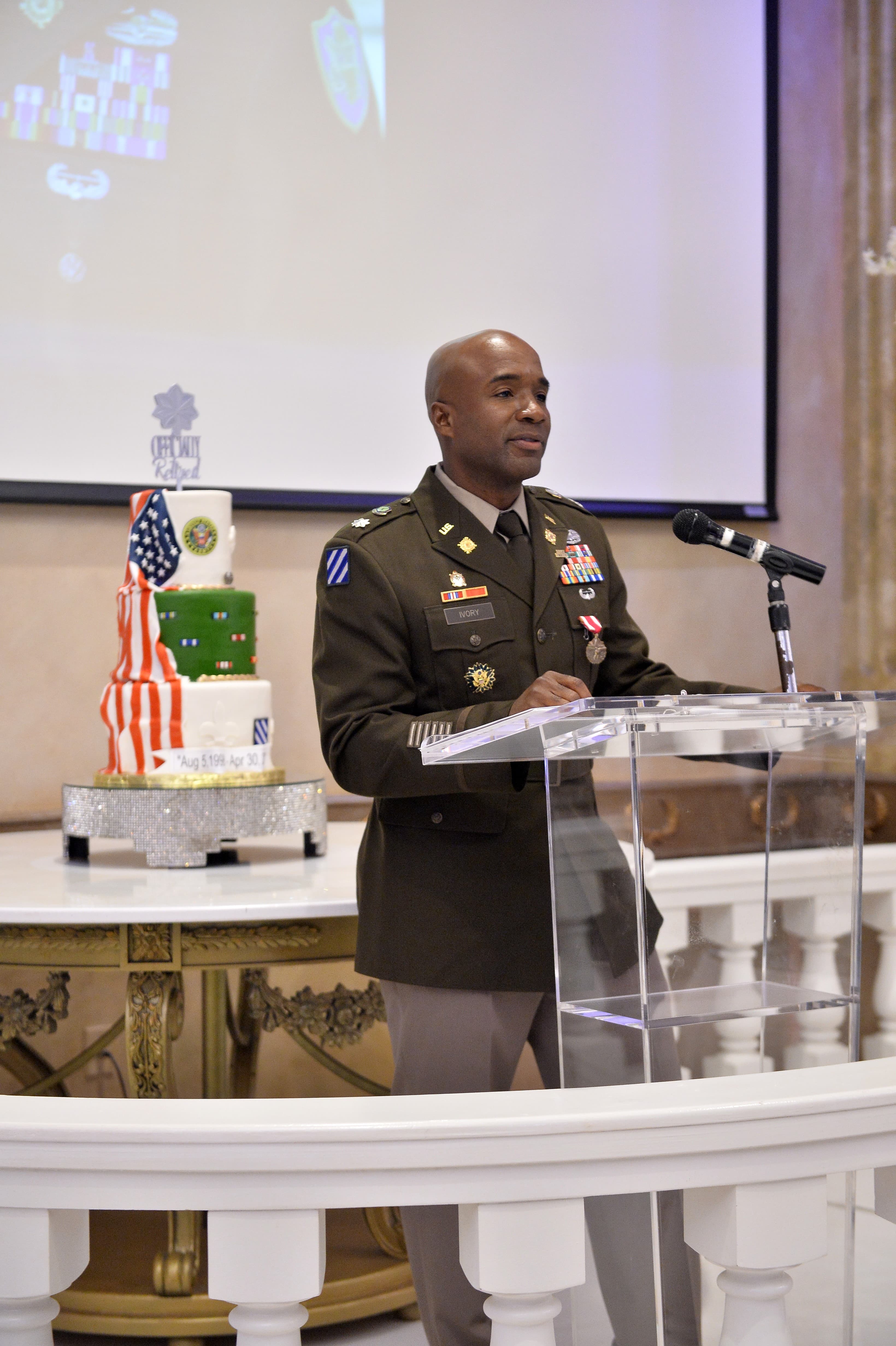 Walter speaking at a podium in military uniform